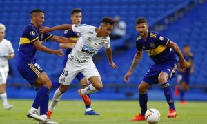 Kaio Jorge of Brazil's Santos is challenged by Lisandro Lopez of Argentina's Boca Juniors